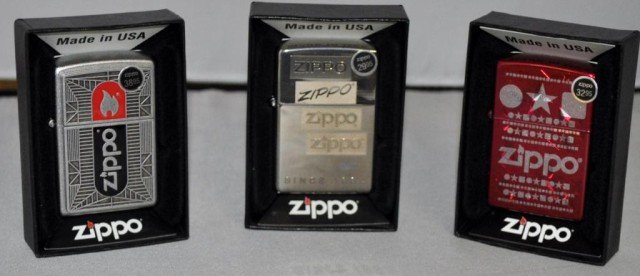 Zippo Lighters, 3 Pieces: All Feature Zippo Logo With Various Other Designs, Measurements: 2 1/4" 2 1/2" x 1/2"