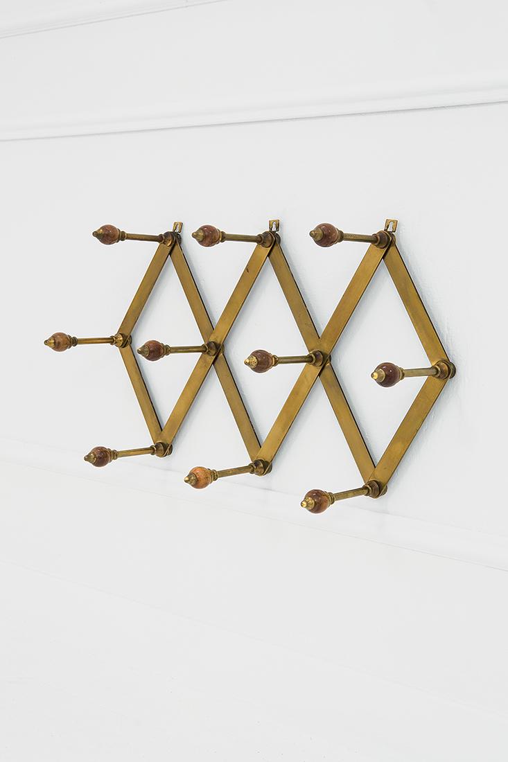 Luigi Caccia Dominioni: Variable-size wall coat hanger, model AT4 Brass, bakelite. Manufactured by Azucena, 1957 ca. 36x61x16.5 cm Literature: Domus, n. 334, settembre 1957, p. 19.