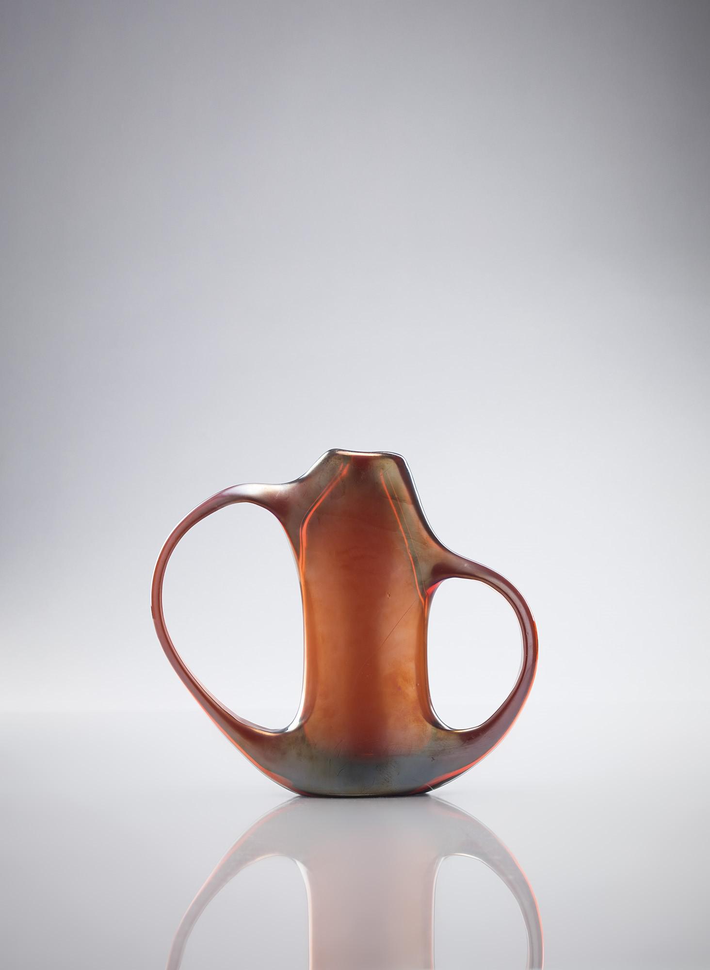 Giorgio Ferro ( 1931 ): Vaso della serie Anse volanti Vetro scuro con superficie fortemente iridata. A.V.E.M., 1952 ca. cm 25x28x6 Literature: F. Deboni, Murano '900. Vetri e vetrai, Bocca Editori, Milano, 1996, p. 88.
