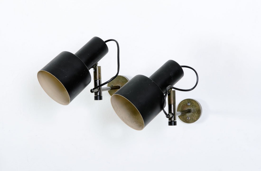 Giuseppe Ostuni: Coppia di lampade da parete Acciaio brunito, riflettori in alluminio laccato orientabili e scorrevoli. Prod. O-luce, 1960 ca. cm 12,5x21 Literature: Catalogo di produzione O-luce.