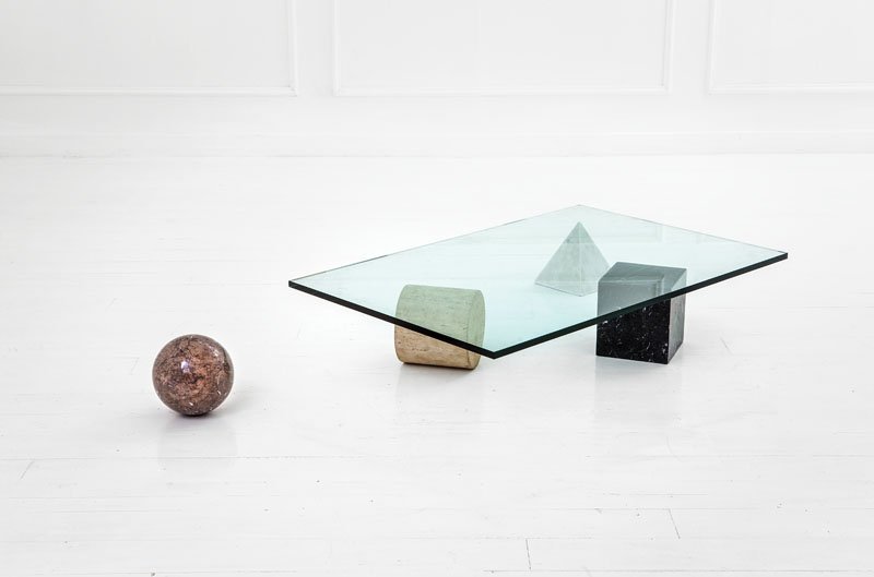 Lella e Massimo Vignelli: Tavolo basso mod. Metafora Travertino, marmo, cristallo molato. Prod. Casigliani, 1979 ca. cm 22x120x79 Literature: G. Gramigna, Repertorio del design italiano per l'arredamento domestico, 1950- 2000,