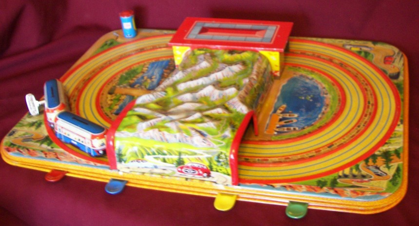 Marke Technofix 284 Tin Litho Toy Racetrack: Marke Technofix 284 Tin Litho Toy Racetrack with One Pair of Buses with Key and Orginal Box, Box Has Two Torn and Missing Portions of the Edges, Top of Box is Intact with Minor Corner Damage, The Two 