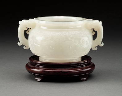 FINE CHINESE WHITE JADE CENSER: 18/19th century. The globular vessel carved in low-relief with archaistic designs, mounted with twin dragon mask handles, standing on a low circular foot. 2.5 in, 6.5 cm, high 5.5 in, 14 cm, over hand