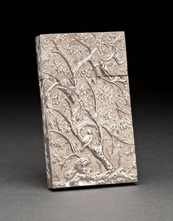 CHINESE EXPORT SILVER CARD CASE: 19th century, probably Canton, maker KC. The rectangular case with removable cover, repousse chased and engraved with birds and foliage on a textured ground, the sides engraved with trailing