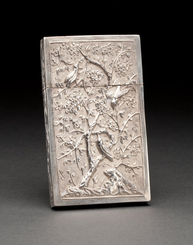 CHINESE EXPORT SILVER CASE CASE: 19th century, probably Canton, maker KC. The rectangular case with removable cover, repousse chased and engraved with birds and foliage on a textured ground within a plain border, the sides engraved w