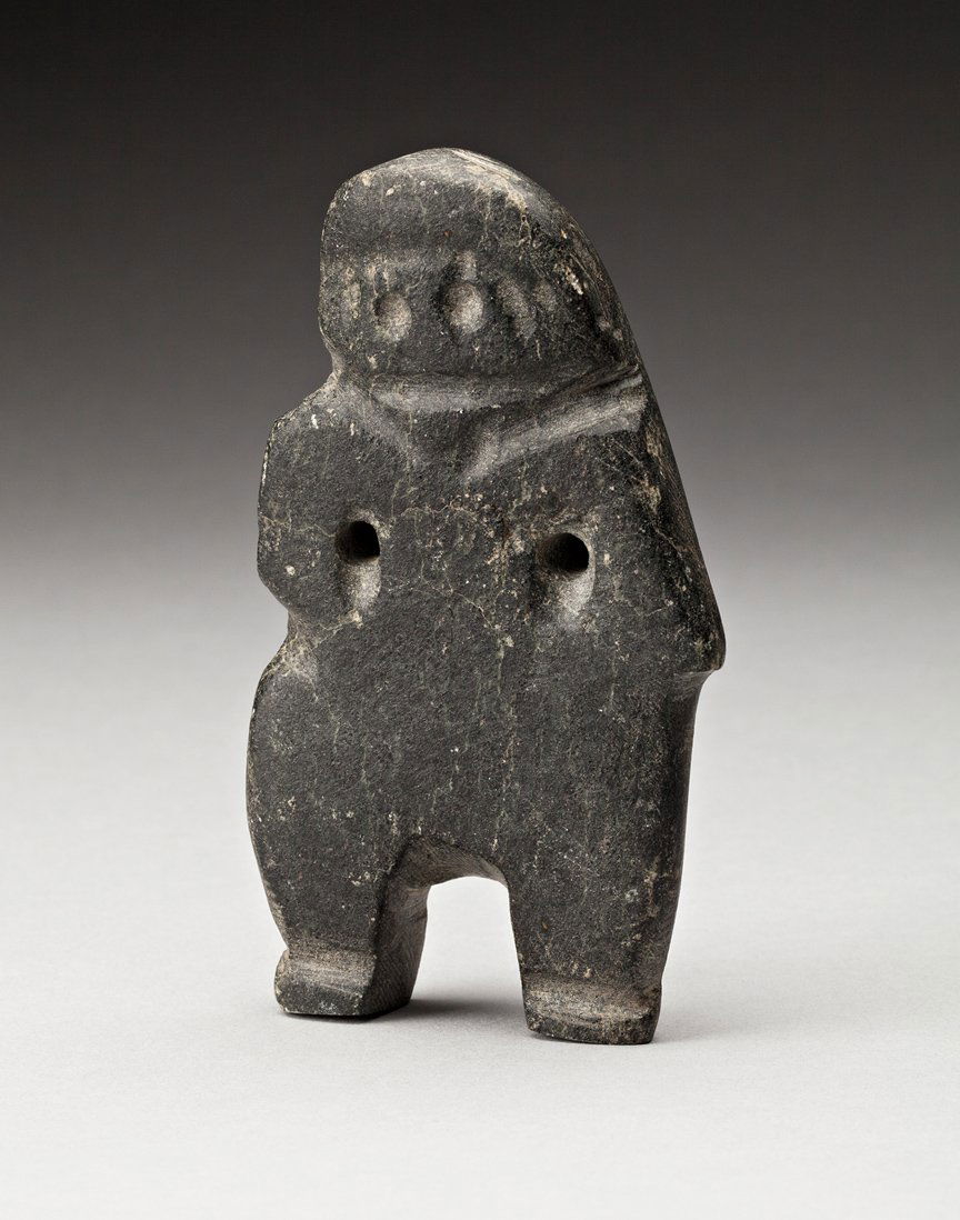 John Kavik (1897-1993): Rankin Inlet, Figure, ca. 1970s, black stone, signed in syllabics, 4.5 x 2.75 x 1 in, 11.1 x 6.5 x 2.5 cm. Provenance: private collection, Toronto. This small works nestles perfectly in one’s hand b