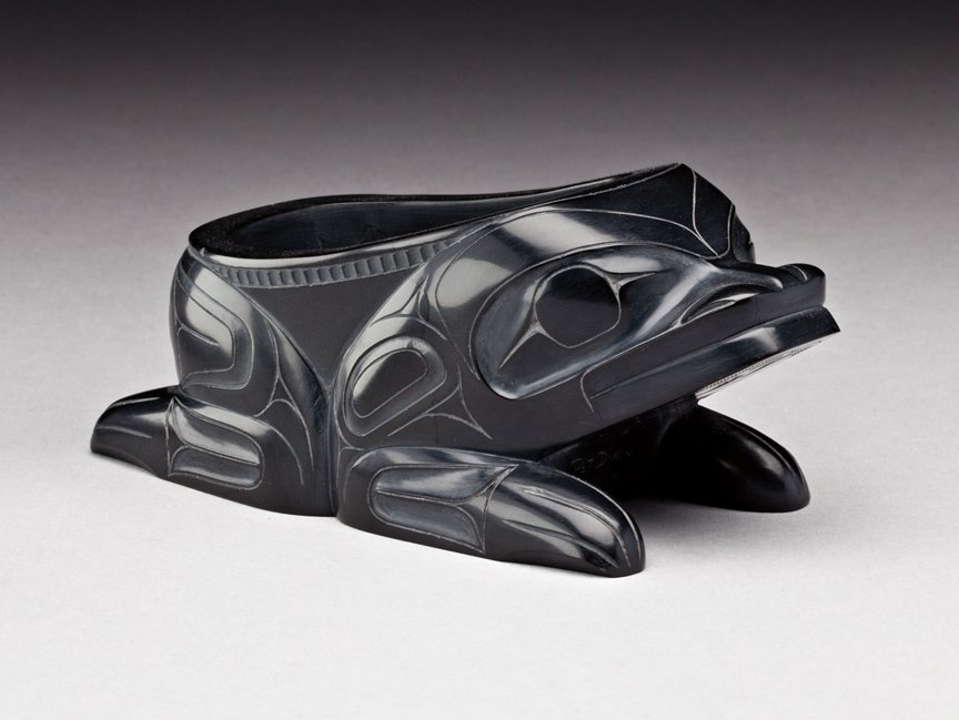 Pat Dixon (1938-): Haida, Frog Bowl, 1981-82, dark grey argillite, signed "Pat Dixon Skidegate B.C.", 2.25 x 5.5 x 2.5 in, 5.5 x 13.7 x 6.5 cm. ... Pat Dixon, who began making art in 1961, carries on a long family tradi
