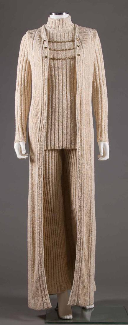 THREE PIECE PARAPHERNALIA PANT SUIT, 1960-1970: Cream cotton & gold lurex rib knit mock turtleneck, flared-hem pants & floor L vest w/ brass chain & button closure, labeled, B 34", W 24", Inseam 30", excellent.