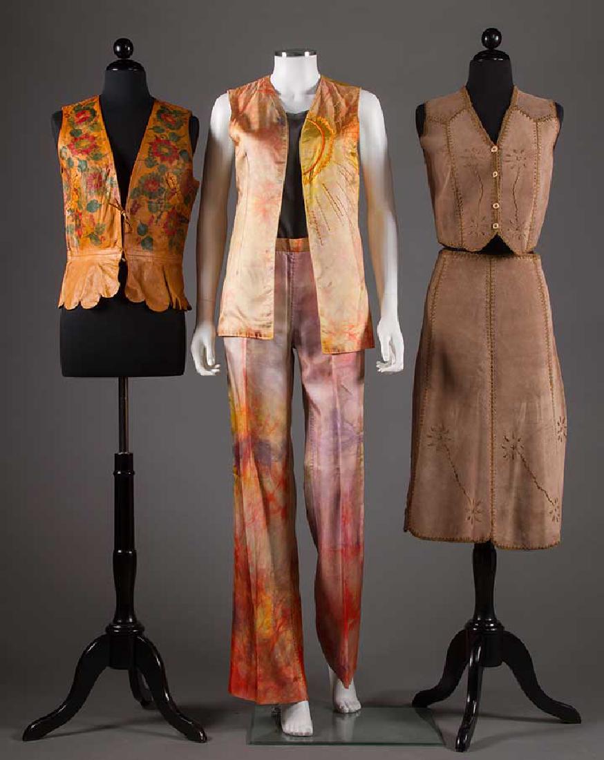 THREE HIPPIE CHICK GARMENTS, 1960s: 1 tan leather vest w/ red & green painted flowers, scallop hem peplum & whip stitch darts & CB seam, B 34"; 1 dark taupe suede vest & skirt, all edges & seams trimmed w/ crochet & embroidery yarn, B 3