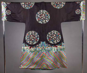 EMBROIDERED ROBE, CHINA, 19TH C: Black silk, polychrome silk embroidery, intricate bottom hem band & 13 rondels w/ beautifully embroidered very small patterned flowers, 8 large & 4 small, Cuff-Cuff ", L 54", (CB seam open, lining sta