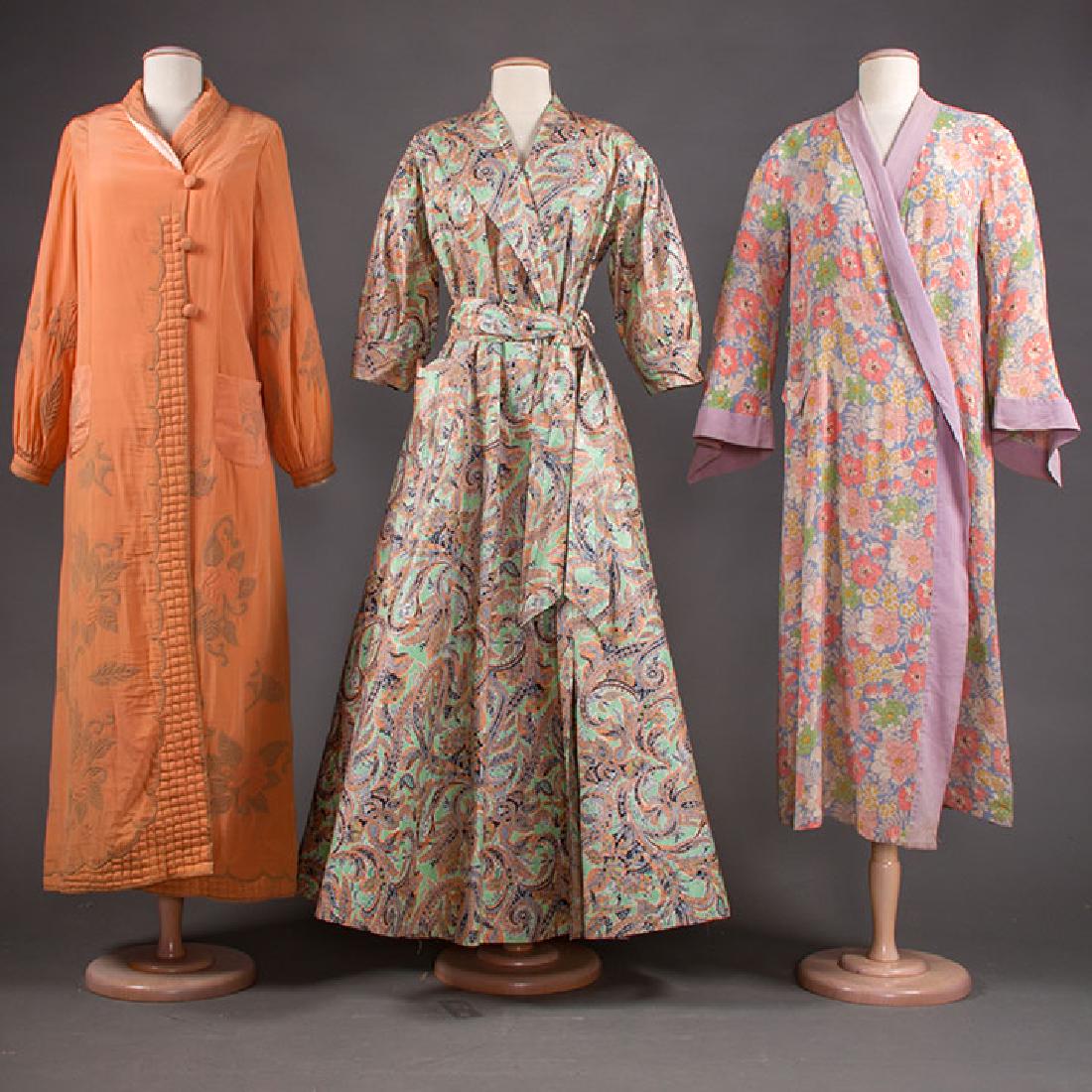 THREE PEIGNOIRS, 1940s: 1 green cotton sateen w/ paisley print in peach & blue, 1 patch pocket, L 55.5", excellent; 1 peach silk w/ trapunto hand-quilted roses in grey, B 38", L 53", (4 stains, belt missing) very good; 1 pea
