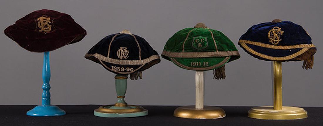 4 BOY'S VELVET BOARDING SCHOOL CAPS, 1889-1912: all w/ metallic monograms & trim, tassels & short visors; 1 sapphire, 1 green; 2 black; very good - excellent