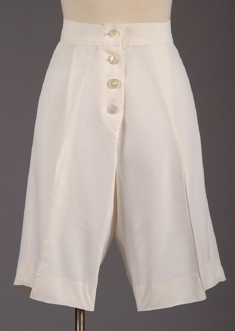 KATHARINE HEPBURN "PHILADELPHIA STORY" SHORTS, 1939: Worn by K.H. on stage in 1939 production of THE PHILADELPHIA STORY, designed by VALENTINA, white sharkskin, 4 front MOP buttons, W 28.5", Ins 10.5", excellent; t/w 1 identical pair, (stains, holes, te