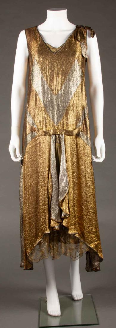 SILVER & GOLD LAME ART DECO DRESS, 1920s: Alternating chevron pattern in silver & gold, side skirt gores of gold lace, B 34", L 48 ", (shredded lining, lace insert at CF neck damaged, small holes to left side hem, minor tarnish) very good.