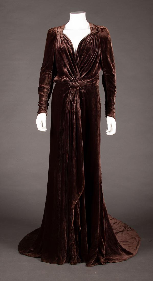 AUBERGINE SILK VELVET BALL GOWN, 1930s: Attributed owner Ethel Barrymore. Sweetheart neckline w/ gathered CF, long 9 button sleeves, trained skirt, labeled "Miss E. Barrymore Bergdorf Goodman", B 40", W 30", L 61"-91", (0.5" tear at hem, 1"