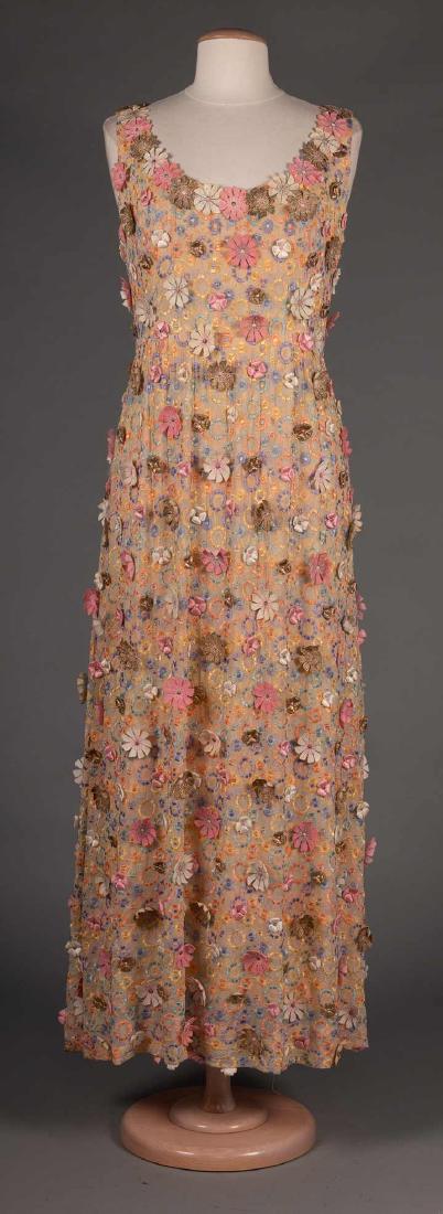 BALESTRA PASTEL FLORAL EVENING GOWN, ROME, 1960s: Sheer white chiffon w/ small embroidered pastel colored blossoms, covered in applique blossoms in shades of pink, white & gold, sleeveless w/ low scoop F & B necklines, nude chiffon lining, label "Bal
