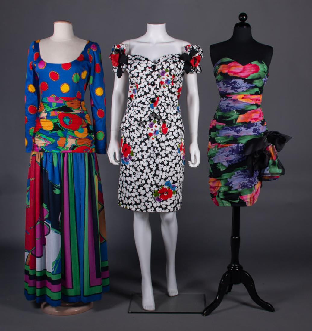 THREE DEADSTOCK PRINTED PARTY DRESSES, 1990s: 1 black w/ white & red floral print, B 36â€, W 26â€, Skt L 23â€, excellent; 1 strapless black w/ purple green & fuchsia print B 34â€, W 27â€, H 38â€, CF L 29â€, scarf 52â€ x 59