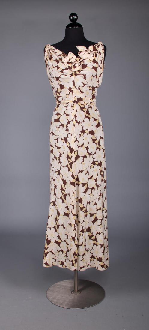 BROWN & WHITE PRINTED SILK TEA DRESS, 1930s: Sleeveless white & pale yellow floral print on brown, self-fabric flowers at neckline, bustle back, B 34", W 28", L 53", (very small smudge stain at back neck & SH, tiny hole at CF bust) very good; t/