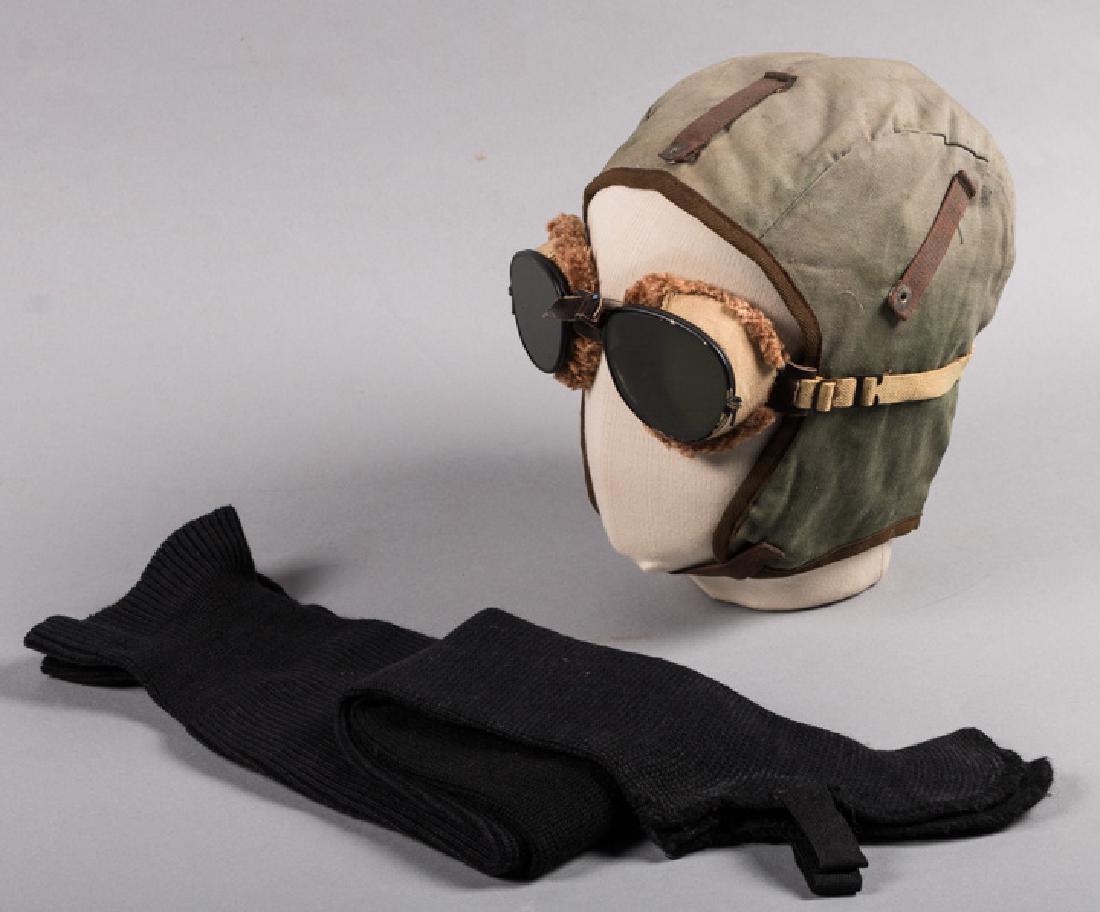 MOTORING & CYCLING ACCESSORIES, EARLY 20TH C.: 1 green canvas motoring, helmet-style hat, ( stains to chamois lining), very good; 1 pair dark glass goggles, (worn elastic, few chips of finish/ scratches on lenses) ,very good; t/w 1 pair men's blac