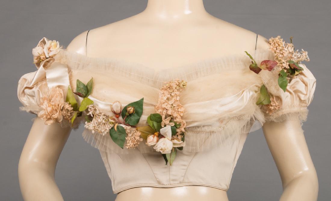 CHARLES WORTH WEDDING BODICE, PARIS: Cream silk faille, back lacing, pleated tulle & cloth flower trim, short puff sleeves, tan cotton twill lining, labeled "Worth, 7. Rue de la Paix. Paris", B 34", W 23", CF L 7", (silk tulle losses & d