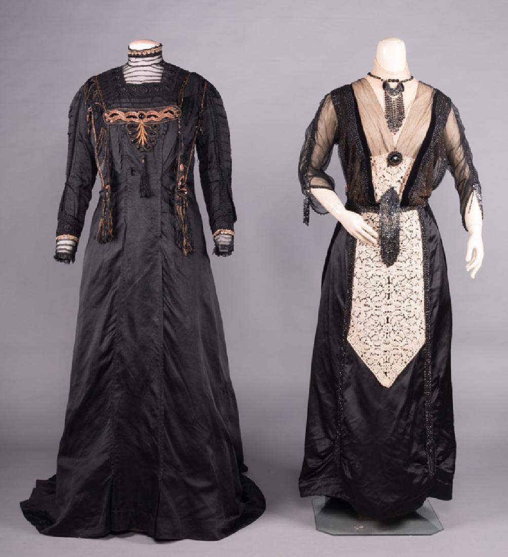 TWO TRAINED BLACK DRESSES, EARLY 20TH C: 1 silk faille w/ gold embroidery & bead trim, B 40", W 34", L 59-74", (fabric worn, tear at CF W, small holes in lace, hem tears, small holes in CB bodice) poor; 1 black silk satin, black net, taupe c