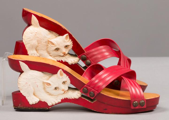 CARVED KITTEN HEEL PLATFORMS, 1940s: 1 pair tropical novelty wedge sandals w/ carved kitten heels of wood, 3" heel, rivetted & crossed plastic straps, both shoes identical, approx. 8 - 8.5 narrow, (mild discoloration, some red scuffs on 