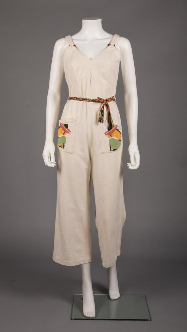 BEACH JUMPSUIT ENSEMBLE, 1930-1940: 3-pc 1930s off white cotton canvas lounging jumpsuit w/ hand painted South Western figures at H patch pockets, Bakelite rings at straps, V-neck to low back, four button closure, matching Bolero w/ som