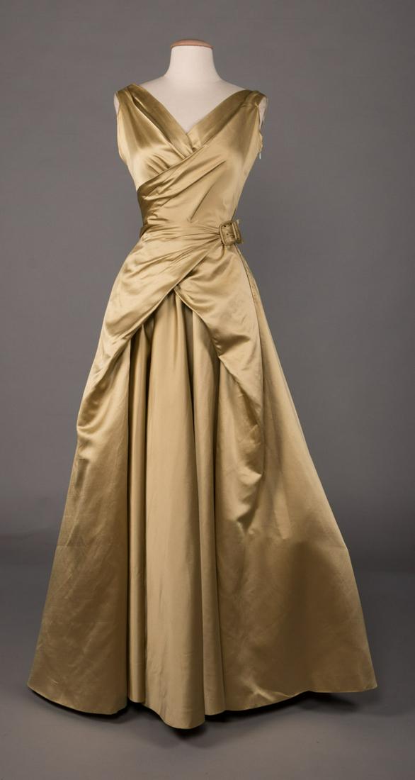 SATIN BALLGOWN, MADRID, 1950s: 1950s silk celery green ball gown w/ wrap bodice to wrap self-belt & full-length slightly train bell skirt, label "Lino, Madrid", B 34", W 22", L 60"-63", (group of stains at back right & CF hem, repa