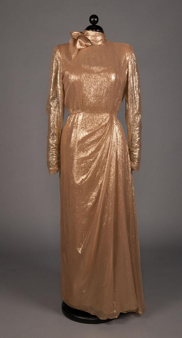 BOB MACKIE FOR LUCILLE BALL LAME GOWN, 1975: 1 sheer gold lame evening gown w/ self-scarf at high neck, strong SH, long sleeve, draped front from left W & plunging V-back, label "Bob Mackie, Elizabeth Arden Salon", B 38", W 30", H 40", L 59", (d