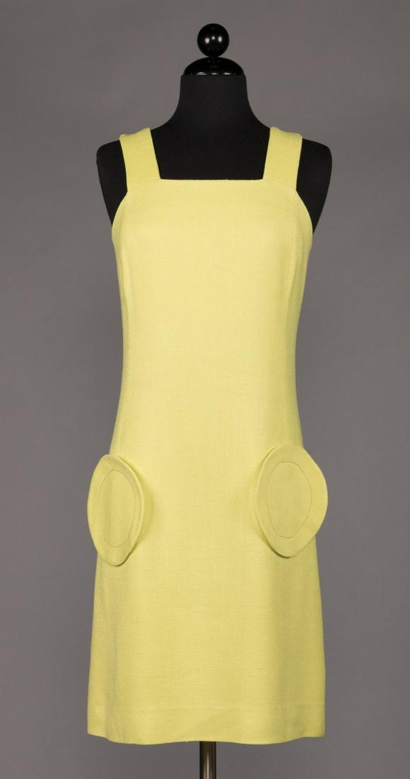 PIERRE CARDIN YELLOW DAY DRESS, s/s 1968: Lime yellow day sheath in linen wool blend w/ wide straps & 6" circle pockets appliqued to princess seam at Hs, CB zipper, B 34", W 28", H 35", L 37.5", label "Pierre Cardin, Jeunesse, Paris", (light 