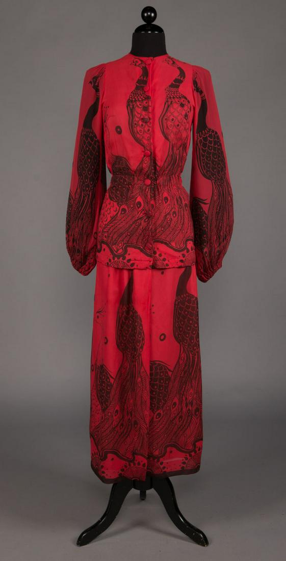THEA PORTER PEACOCK PRINT MAXI-DRESS, LONDON, 1970s: 2-pc day ensemble in tomato red chiffon w/ black peacock motif, blouse w/ button front, jewel neck, bishop sleeves & elastic W, wrap skirt to ankle, 3 button hook & eye closure at CF, label "Thea Port