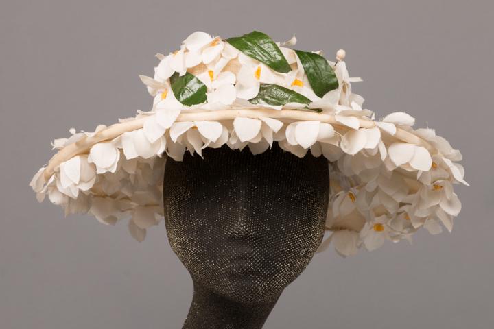 BALENCIAGA COUTURE FLORAL HAT, PARIS, 1950s: Couture late 1950s 3 dimensional white floral & leaf cartwheel day hat w/ two 3" white silk balloon top hatpins & 3" buckram insert, label "Balenciaga, Paris, #4287", (some leaves & flowers curling, f