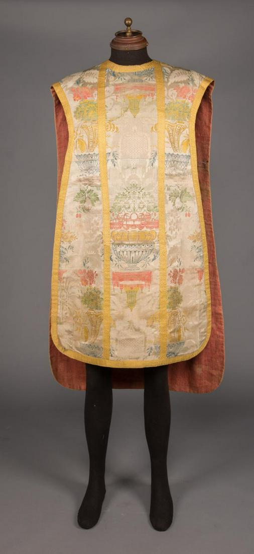 PASTEL BROCADE CHASUBLE, ITALY, c. 1750: 1750s Italian Chasuble of silk brocade in shades of yellow, shrimp pink, blue & green on bone ground, SH-SH 22.5", CF L 37.5, CB 45", (light water mark at seat, some separations at trim, 0.25" holes a