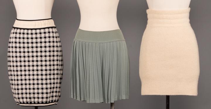 THREE AZZADINE ALAIA KNIT MINI SKIRTS, PARIS, 1990 &: 3 knit body con mini skirts or shorts, all labeled "Alaia": 1 herringbone SS 1991, Look 45, W 26", L 19" & 1 sea foam green pleated shorts, SS 1990, W 30, L 15", (tiny stain to right lap) & 1 cream kn