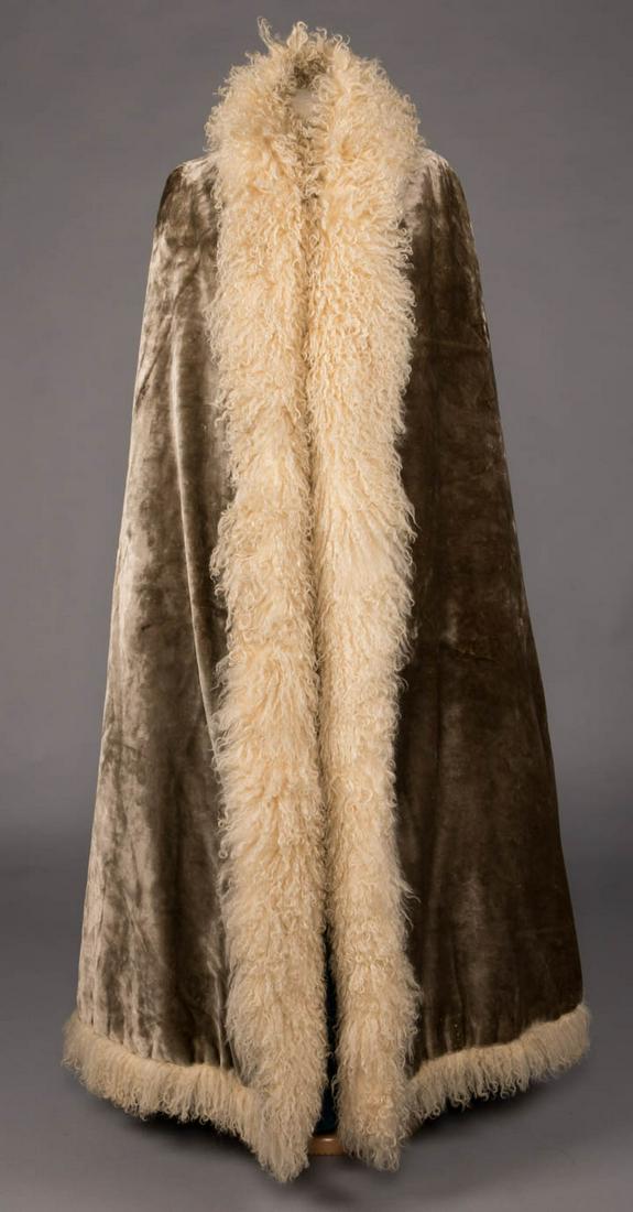 EARLY REDFERN GREY PLUSH EVENING CAPE, PARIS, c. 1885: Grey silk plush full length, bustled evening cape lined in Mongolian lamb, 2 interior slit pockets, Parisian made for Russian market,very early "Redfern" label, L 52", (holes at right B under collar, 