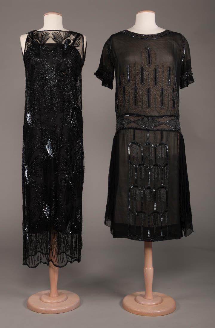 TWO BLACK BEADED EVENING DRESSES, 1920s: 1 sleeveless black net w/ black bugle beads & facetted sequins in spray motifs, late 1920s B 36", L 52", (holes in net esp. at SHs & B, sequin & bead loss, slip N/I) good; 1 short sleeve black silk ch