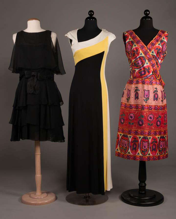 TWO ESTEVES & ONE OLEG CASSINI, AMERICA, 1960-170s: 2 Esteves: 1 sleeveless black chiffon tiered cocktail dress w/ black silk satin sash w/ CF bow, B 34", W 33", L 37", excellent; 1 black & white Banlon evening dress w/ sweeping yellow color block, B 3