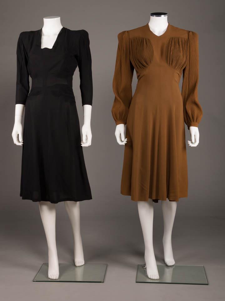 TWO AFTERNOON DRESSES, AMERICA, c. 1945: 1 black crepe, novelty squared neckline, 3/4 length sleeves, tailored shaping done w/ tendril smocking to SHs, B & either side of W, CB zip closure, B 37", W 27", L 43.5", (tiny seam opening at CF W, 