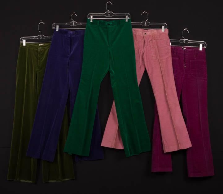 FIVE PAIR CORDUROY OR VELVET JEANS, FRANCE, 1969-1976: 1 purple cotton velveteen, 3.5 cm wide W band, flared wide leg, CF zipper closure, c. 1976, label "Gaston Jaunet", W 25", inseam 30.5" (crush marks at W band); 1 olive velvet labeled "Marianne", W 28"