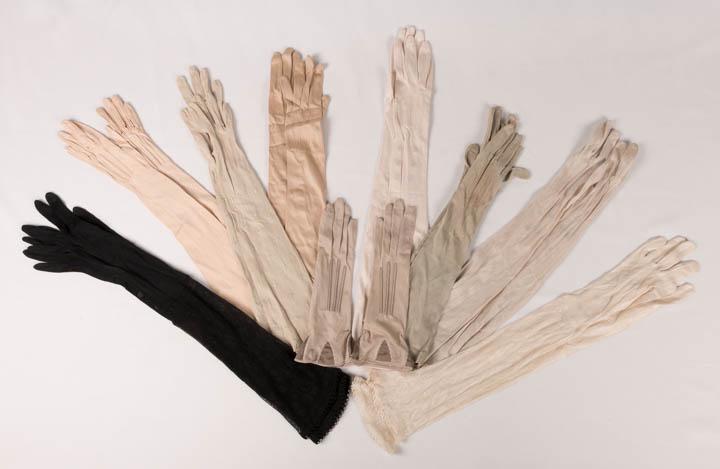 GENEROUS LOT LADIES GLOVES, AMERICA, 1890-1920: 2 identical silk evening gloves: 1 black & 1 white w/ knitted floral cascades edged w/ band of Greek circle motifs, both L 23", both excellent; 1 pair pale celadon w/ embroidered , L 18.25" (minor wea