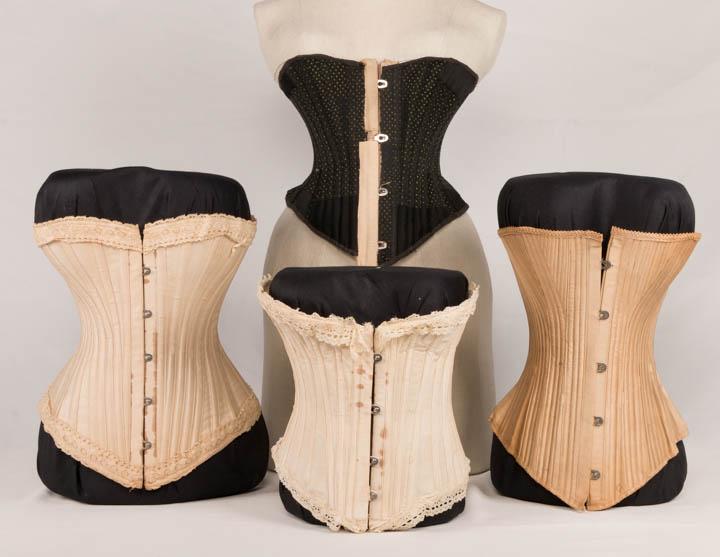 FOUR CORSETS, 1890-1900: All back lacing & front closure: 1 cotton drill, lace at both edges, 1890's, stamped "Royal Worcester", B 28", W 19.5", L 10.5-12.5", (staining, ribbon in top trim broken, C lacing grommet detached); 