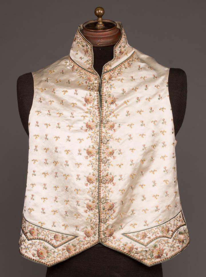 GENTS EMBROIDERED WAISTCOAT, FRANCE, 1790: Gents embroidered waistcoat of cream silk satin embroidered w/ satin stitch & French knot floral & sprig motifs in shades of celadon, cinnamon, blues & yellows, self-covered & embroidered CF button cl