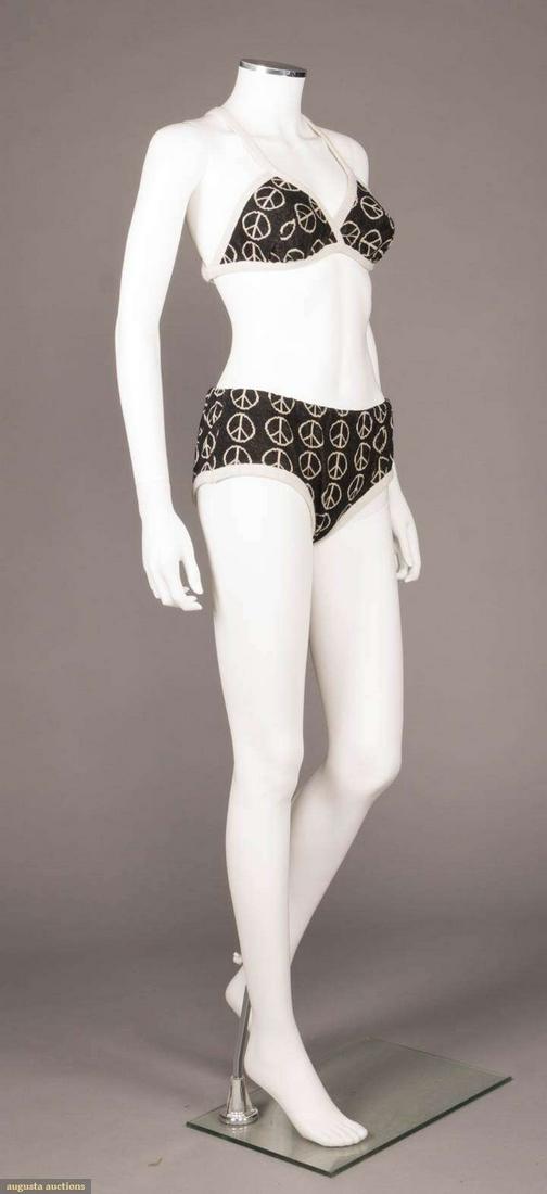 ICONIC ALVIN DUSKIN PEACE SIGN BIKINI, AMERICA, 1967: Double woven wool w/white peace sign motif vertically arranged on black ground edged w/ white wool band to straps crossing over center back to tie, label "Alvin Duskin", top L 13", bottoms L 8", W 26"