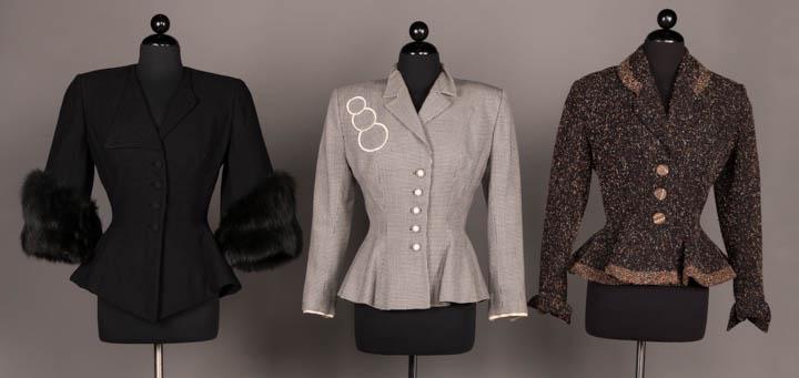 THREE LILLI ANN JACKETS, AMERICA, c. 1950: All wool w/ fitted W & flared peplum & w/ label "Lilli Ann of San Francisco": 1 black w/ oversized dyed fox trimmed cuffs, asymmetric lapel, CF self-covered button closure peplum terminating in CF V,