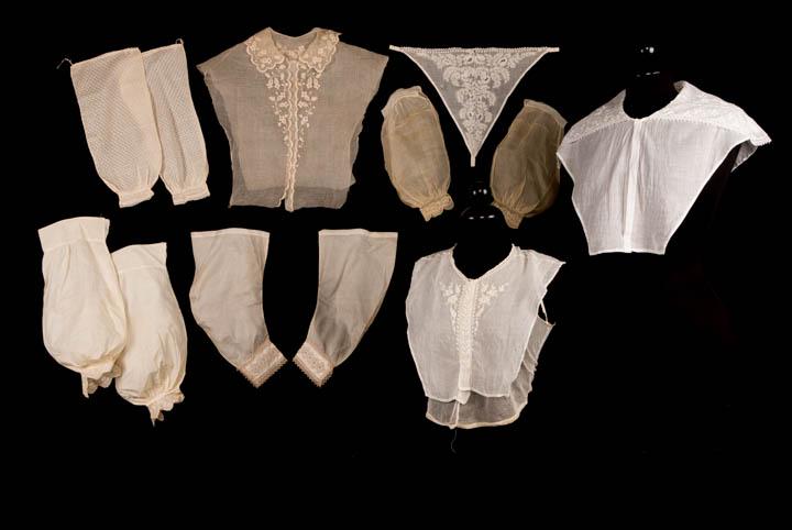 EMBROIDERED COTTON DICKIES & SLEEVES, 1810-1860s: Dickie size range, B 31-33", L 14.5-19": 1 cotton w/ collar & whitework embroidery in campion motif, 1840s, (cut edges, fraying); 1 w/ embroidered bertha collar, 1830s; 1 net vest w/ V-shaped insert p