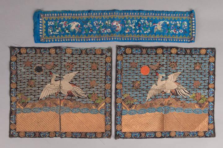 PAIR OF KESI CIVIL RANK BADGES, CHINA, 19TH C: 2 matching Qing dynasty crane Chinese civil rank badges (buzi) of left facing silver cranes flying above golden sea towards scarlet sun & moon for woman's kesi vest or robe: 1 w/ sun for back, 11" x 1