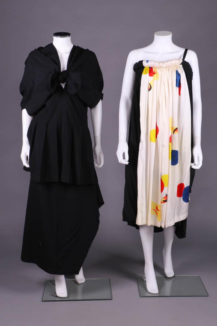 REI KAWAKUBO, YOHJI YAMAMOTO GARMENTS, JAPAN, 1980s: 2-pc black worsted wool twill ensemble c/o complex gathered & pleated fan shaped bodice w/ deeply pleated midriff into let out pleats for full hem & cut edged fraying knot bow to CF, asymmetrical ankl