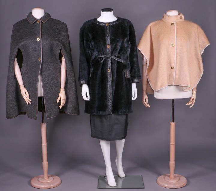 THREE BONNIE CASHIN OVERCOATS, AMERICA, 1958-1972: All w/ leather bindings & brass oval turn lock closures, label "Sills & Co., A Bonnie Cashin Design": 1 double faced heathered grey & brown brushed wool cape w/ convertible collar, CF, SS arm slits & 