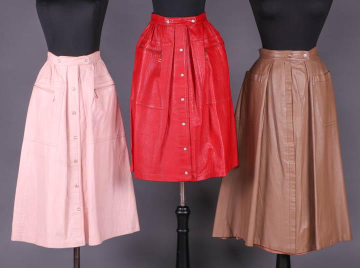 THREE BONNIE CASHIN LEATHER SKIRTS, AMERICA, 1952-1960: All label "Sills & Co., A Bonnie Cashin Design": 1 blush pink 4 piece gored skirt gathered in W band w/ oversized patch pockets & inserted zip opening, agate snap closures to CF & W band, 1952-1958, W