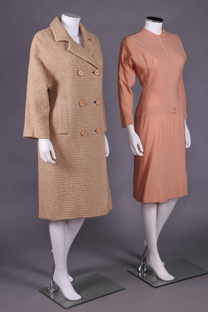 IRENE DAY ENSEMBLE, AMERICA, 1950-1955: 2-pc ensemble c/o double breasted boucle coat w/ set in dolman sleeves, notched collar, flapped fitchet pockets, crepe silk lining & peach wool day dress w/ long dolman sleeves, drop W w/ faux belt to